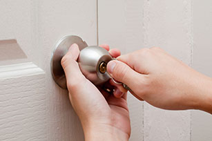 Home locksmith fixes door lock